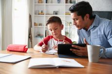 Dad helping son with homework