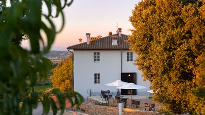 exterior view of the laqua vineyard resort in tuscany