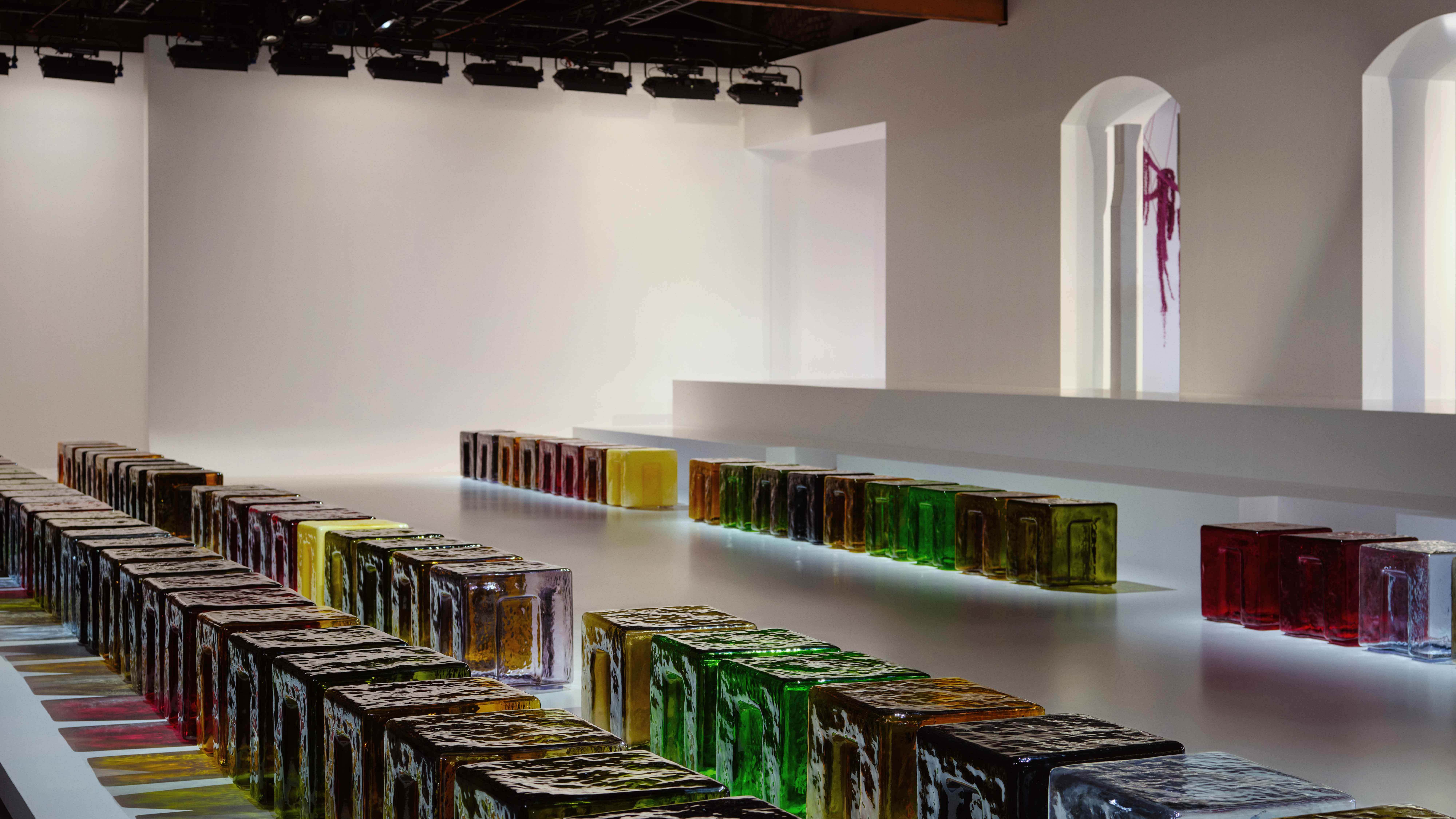 Glass stools of multiple colours by 6AM at the Bottega Veneta runway show