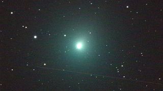 A 120-second exposure of Comet 46P/Wirtanen taken with an iTelescope 50-mm refractor at an observatory near Mayhill, New Mexico. A rocket's upper stage passed through the telescope's field of view during the exposure, creating the streak below the comet.