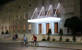 Cyclists passing the front of the building