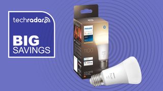 Philips Hue light bulb and box on purple background with white text reading 'TechRadar big savings'
