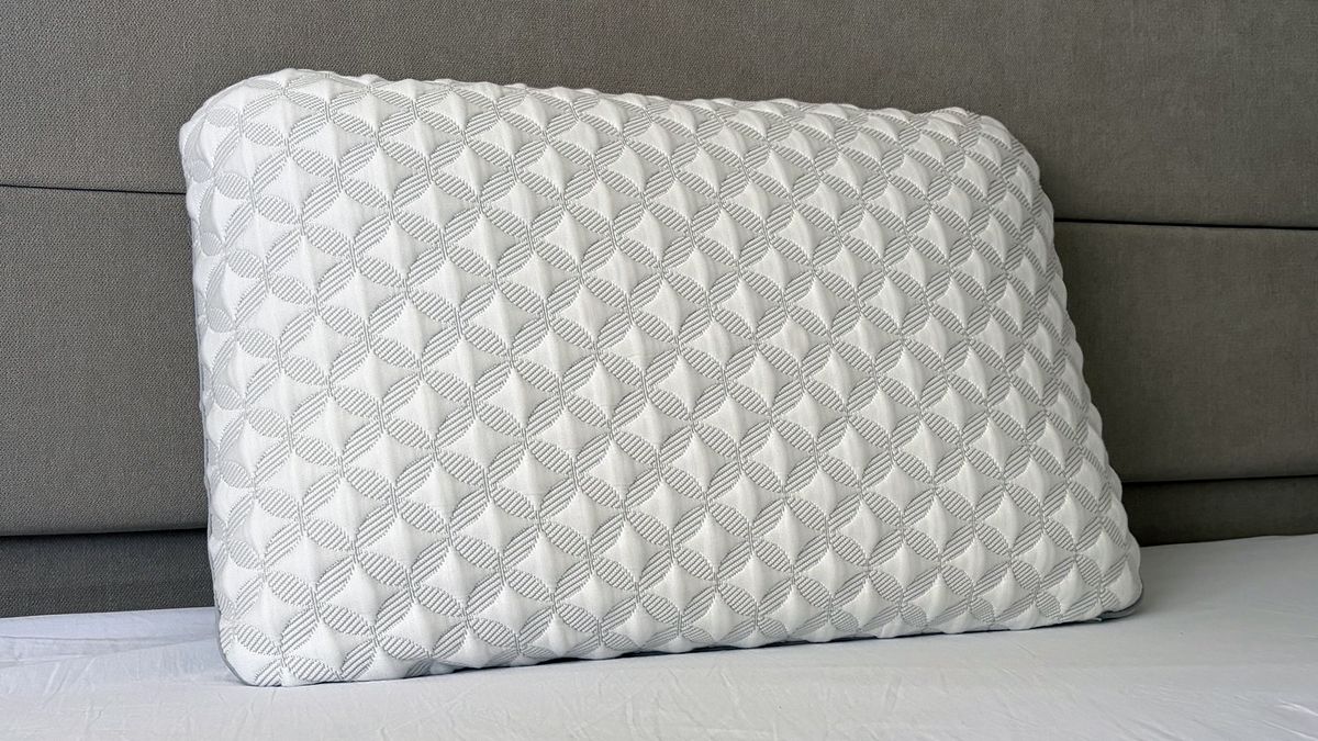 A close up of the Helix Talalay Latex pillow resting against the headboard in our reviewer's bedroom