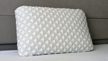A close up of the Helix Talalay Latex pillow resting against the headboard in our reviewer's bedroom
