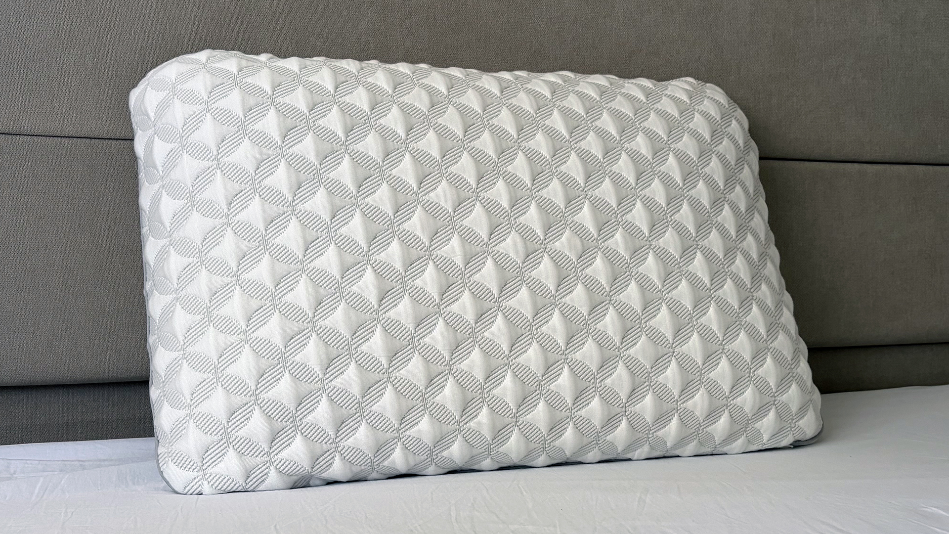 A close up of the Helix Talalay Latex pillow resting against the headboard in our reviewer's bedroom