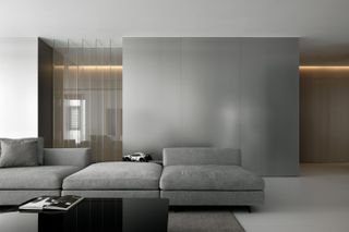 Penthouse in Chaozhou by AD ARCHITECTURE focusses on grey cushion sofa.