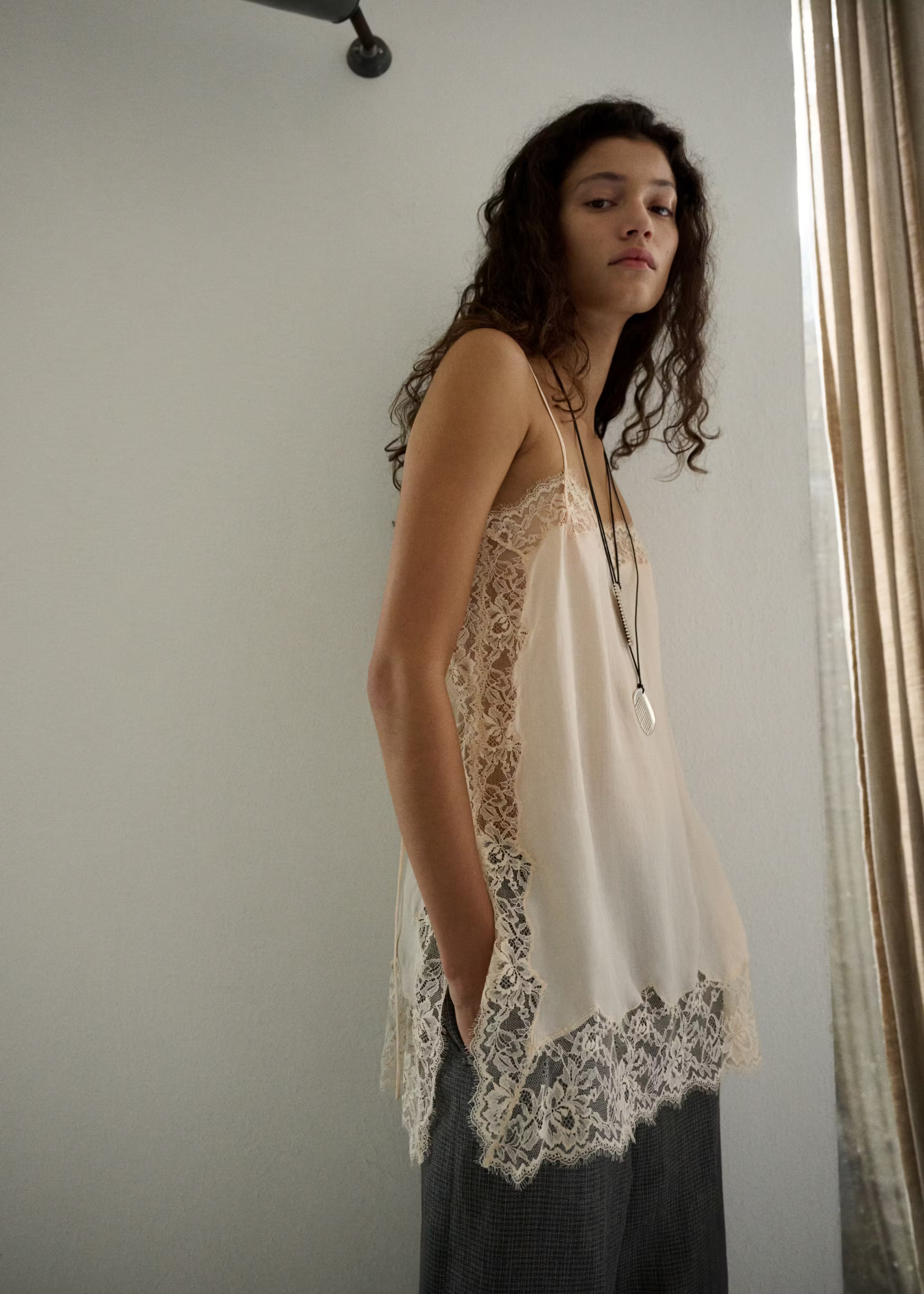 A model wearing a Mango white lace camisole