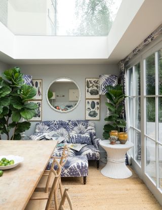 Garden room with blue patterned sofa, larger mirror and sky light