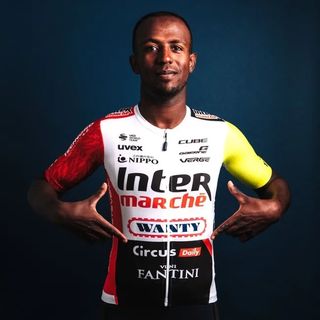 Biniam Girmay in the new Intermarché-Wanty kit, with a red right arm and a neon yellow right arm