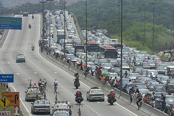 The leaders have plenty of room on the road as opposed to the traffic on the other side.