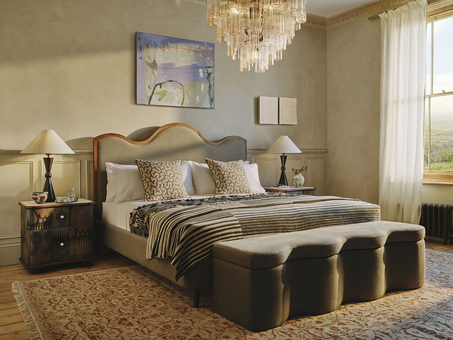 bed with wavy headboard in a large bedroom with paneling