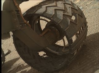The wheel deal. Curiosity Mars rover is suffering from wheel wear, as seen in this image, taken August 16, 2015, Sol 1076. Designs are in the works for a new set of heftier wheels for the NASA Mars 2020 robot.