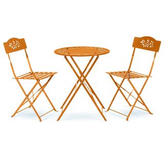 An orange bistro set with leaf cut-outs on the seats