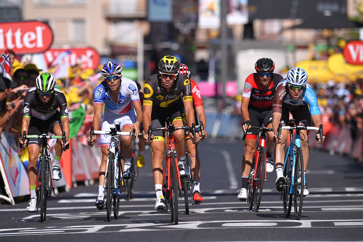 A group of chasers hits the finish line on stage 15 of the Tour de France.