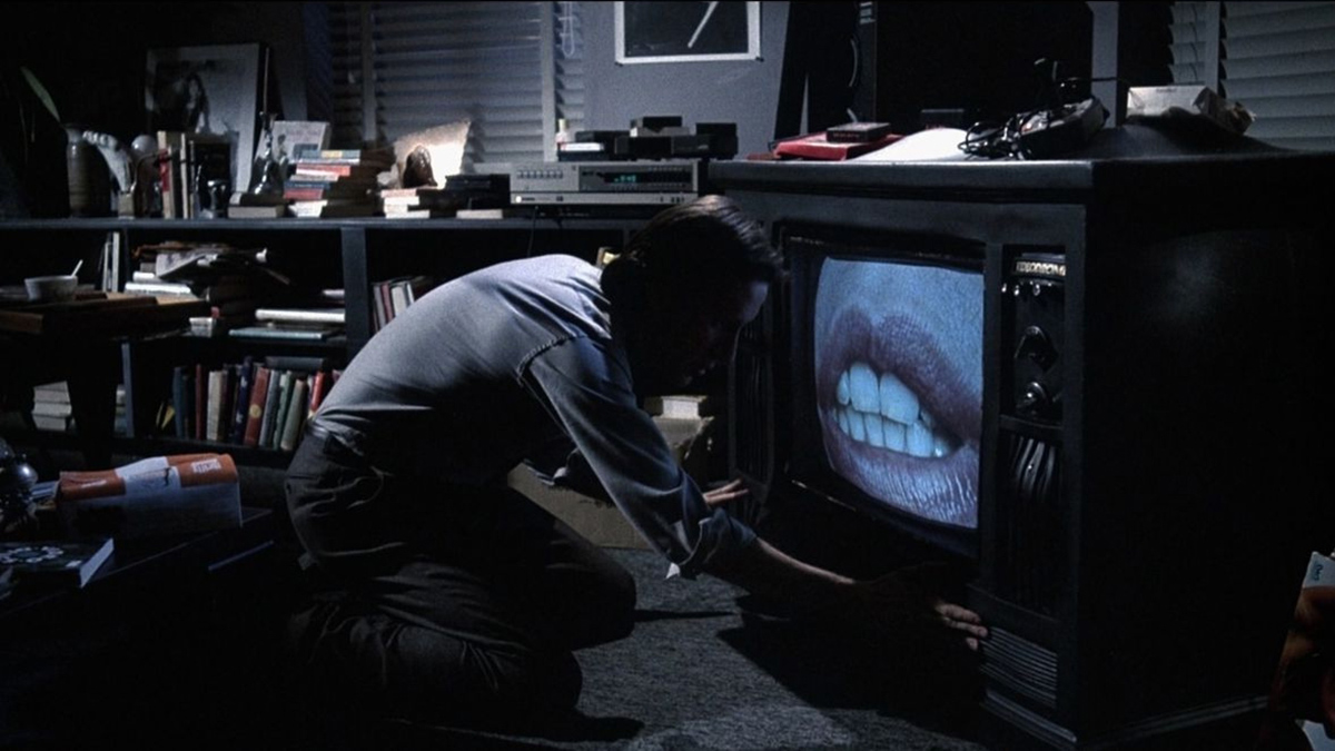 James Woods about to kiss a TV in Videodrome