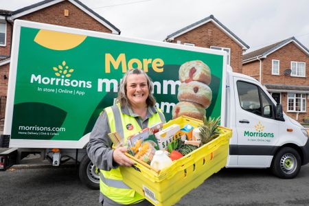 Woman holding a Morrisons Christmas food delivery