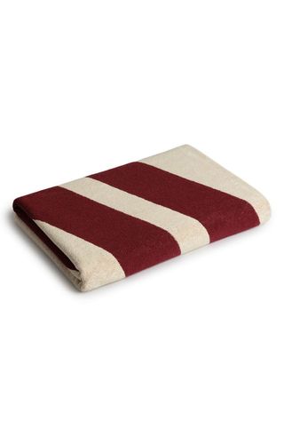 a red and off-white striped beach towel