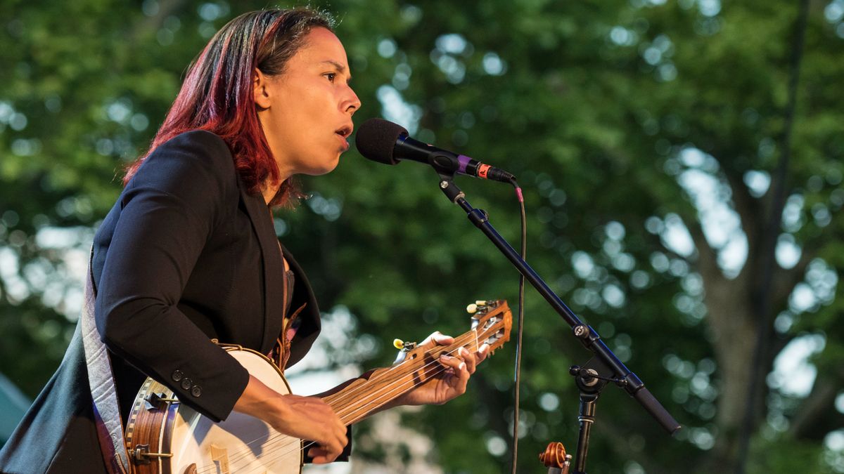 American folk and country singer and multi-instrumentalist Rhiannon Giddens performs on banjo with her band at Central Park