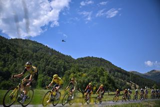 Jumbo-Visma's Danish rider Jonas Vingegaard wearing the overall leader's yellow jersey (2nd L) cycles with the pack of riders during the 14th stage of the 110th edition of the Tour de France cycling race, 152 km between Annemasse and Morzine Les Portes du Soleil, in the French Alps, on July 15, 2023. (Photo by Marco BERTORELLO / AFP)