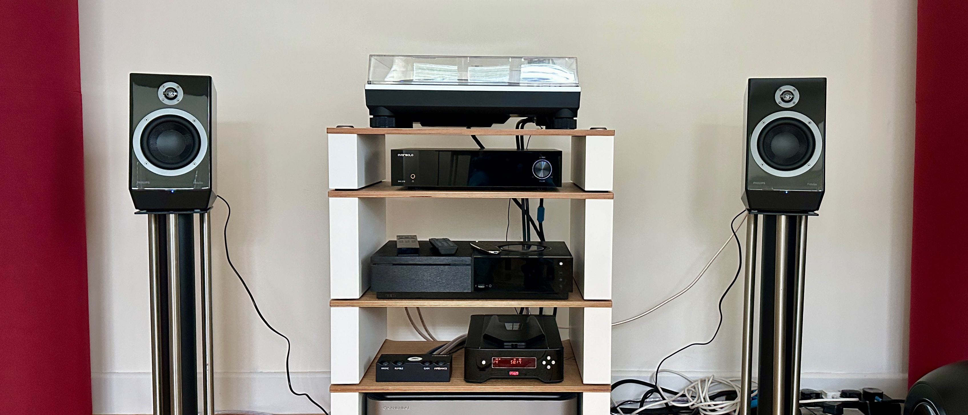 The Philips Fidelio FA3 speakers on stands, on either side of a hi-fi rack with various components on it