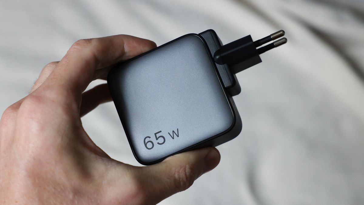 Ugreen Nexode 65W charger with European plug held in a hand