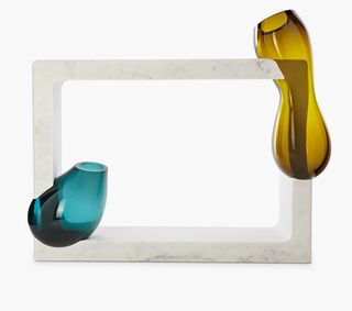 Two pieces of blown glass, one yellow and one blue, moulded onto a piece of white marble
