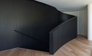 Top of staircase, black walls