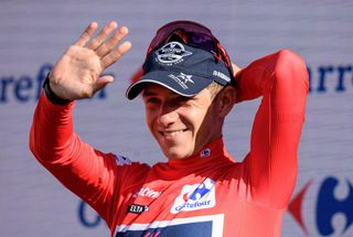 Team Quick Steps Belgian rider Remco Evenepoel waves on the podium wearing the overall leaders red jersey after the 20th stage of the 2022 La Vuelta cycling tour of Spain a 181 km race from Moralzarzal to Puerto de Navacerrada on September 10 2022 Photo by Oscar DEL POZO CANAS AFP Photo by OSCAR DEL POZO CANASAFP via Getty Images