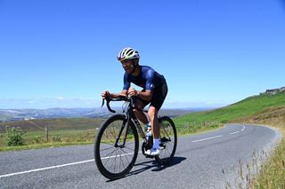 Image shows a rider cycling in hot weather.