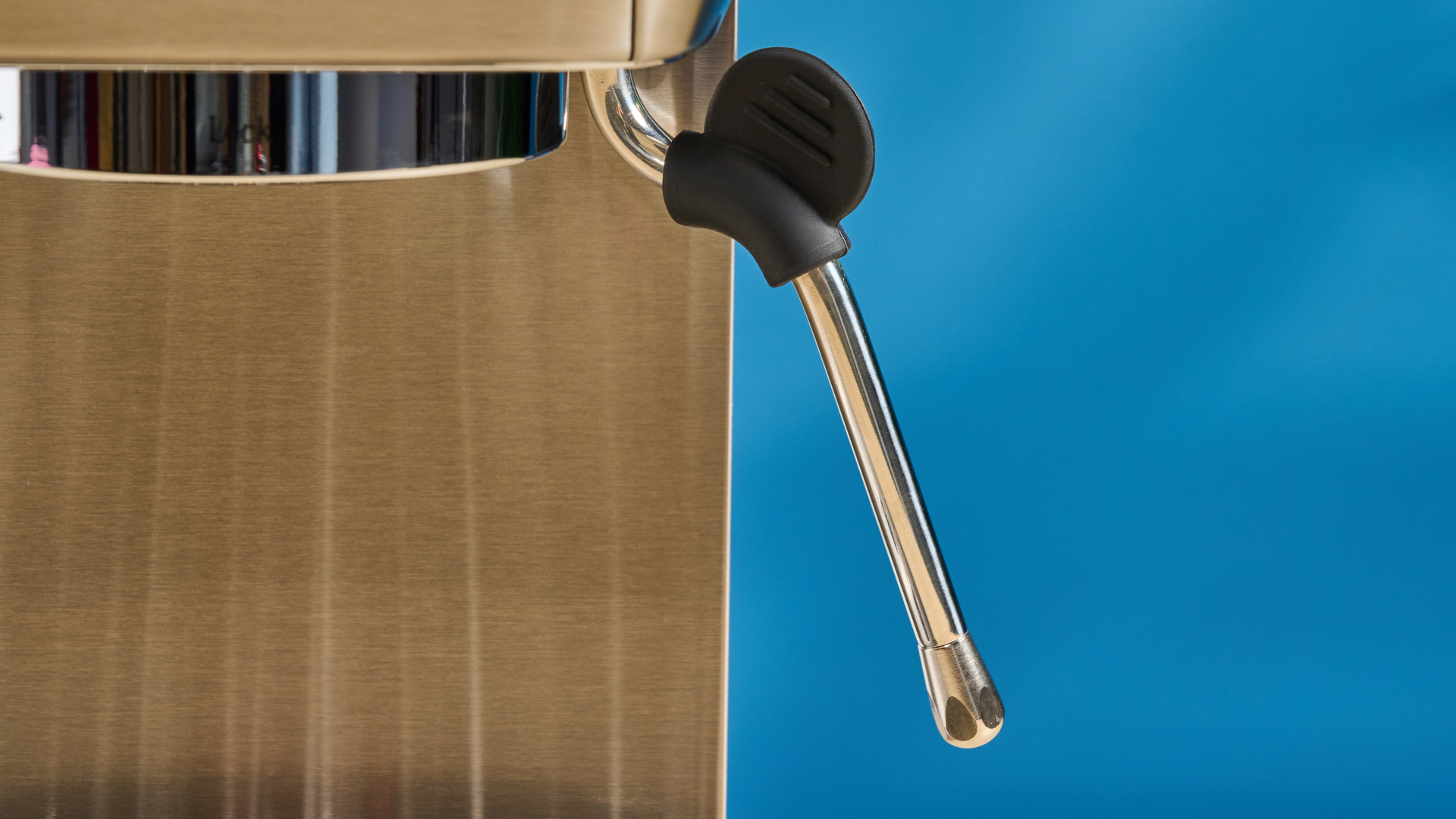 the casabrews 3700 essential espresso machine in silver with a compact footprint and shiny reflective metal casing