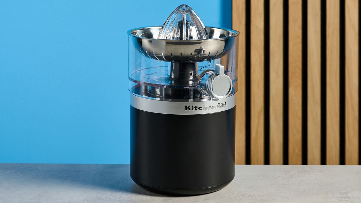 KitchenAid Go Cordless Citrus Juicer in matte black photographed in front of a blue background.