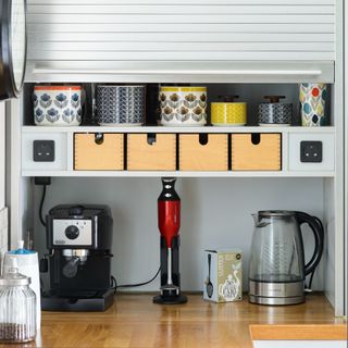 A kitchen worktop with storage and appliances