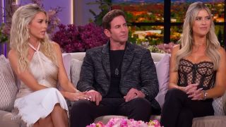 Heather Rae holds Tarek's hand while Christina is also on the couch