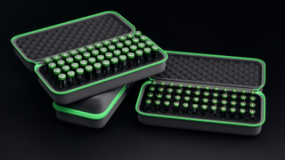 The Klvr Charger Pro with a neon green hard case and many neon green rechargeable batteries. 