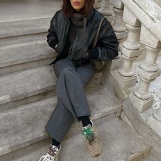 debora rosa wearing black leather jacket grey pants and new balance sneakers