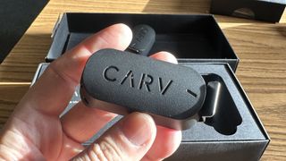 The Carv device held in hand