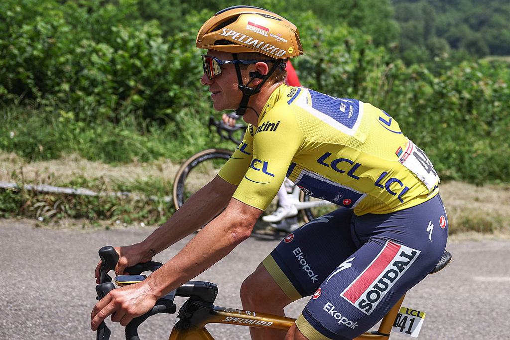Soudal Quick-Step's Belgian rider Remco Evenepoel wearing the overall leader's yellow jersey cycles during the 5th stage of the 77th edition of the Criterium du Dauphine cycling race, 183 km between Saint-Priest and Mâcon, on June 12, 2025. (Photo by Anne-Christine POUJOULAT / AFP) (Photo by ANNE-CHRISTINE POUJOULAT/AFP via Getty Images)