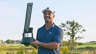 Bryson DeChambeau poses with the trophy after victory in LIV Golf Chicago