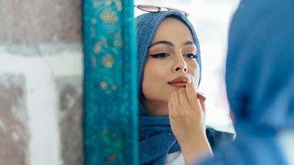 woman applying makeup