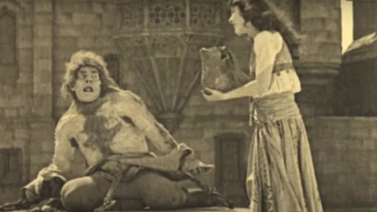 Lon Chaney receiving a kind gesture from Patsy Ruth Miller in The Hunchback of Notre Dame