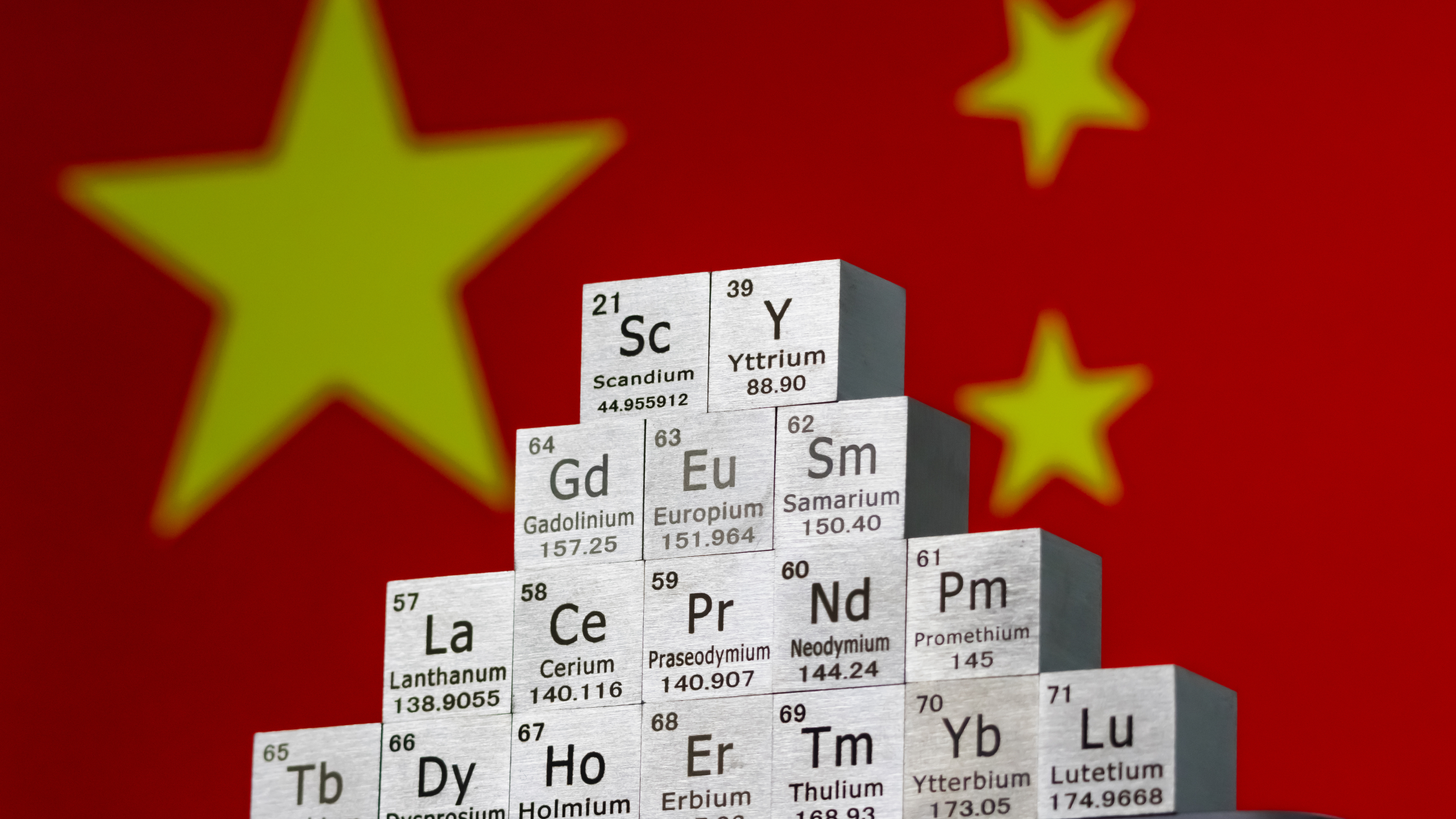 Chinese flag with rare earth minerals background