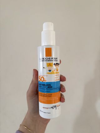 Mica Ricketts holding La Roche-Posay Anthelios UV Mune 400 Dermo Pediatrics Invisible Spray SPF50+