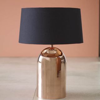 room with pink wall and copper table lamp