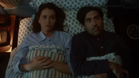 Felicity Jones and Jason Schwartzman lying in a single bed together in the film Oh.What.Fun