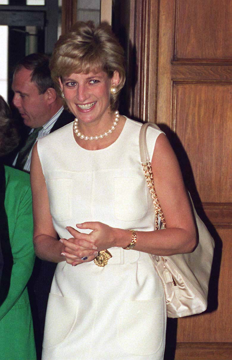 Princess Diana visiting Chicago wearing a white dress and pearls