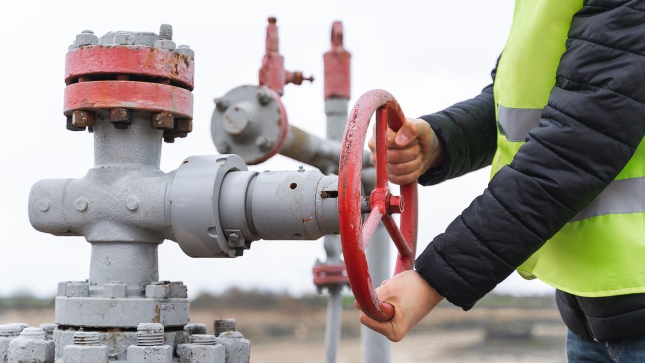 Engineer turning a gas pump