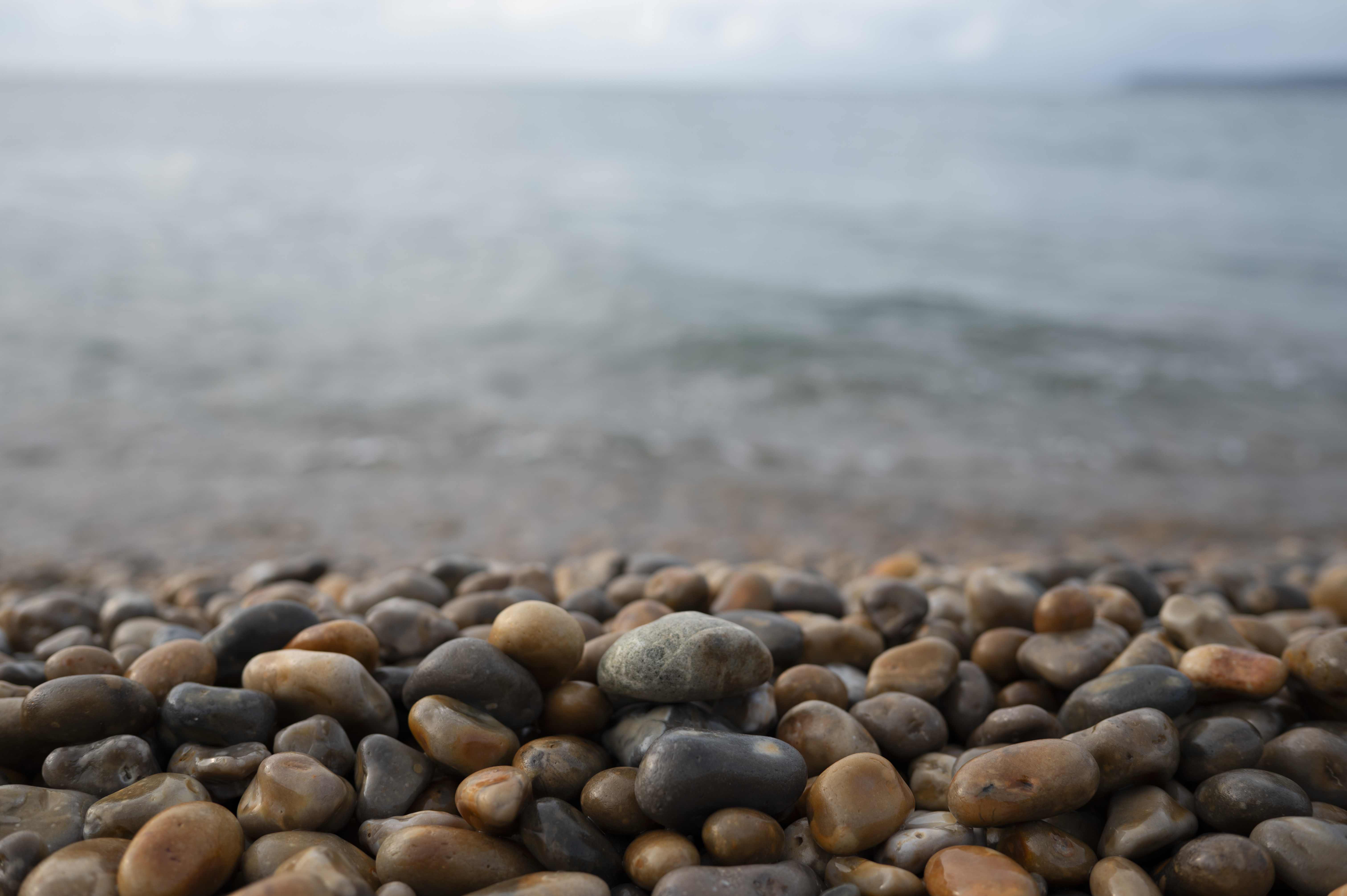 Pebbles on a beach, taken with the Nikon Z 35mm f/1.4 lens