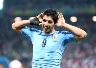 Luis Suarez cups his hands to his ears in celebration after scoring for Uruguay against England at the 2014 World Cup