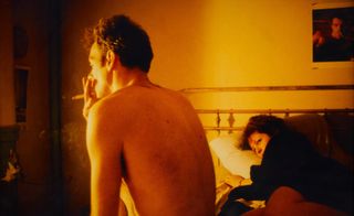 Man smoking in bed, Nan Goldin artwork, part of A Woman’s Right to Pleasure exhibition at Sotheby’s LA