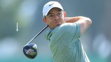 Rory McIlroy of Northern Ireland plays his tee shot on the third hole on Day One of the Dubai Invitational at Dubai Creek Golf